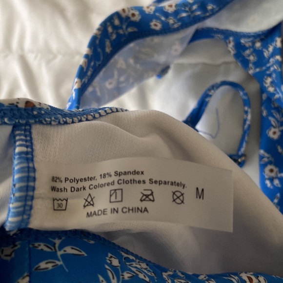 A medium size blue swimsuit with floral design. - Picture 4 of 7